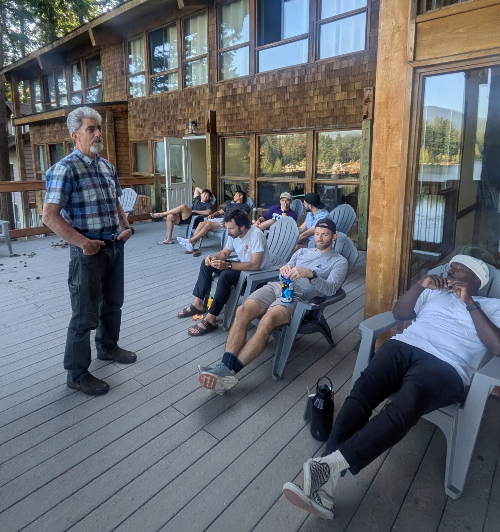 Men gathered on the lodge deck talking together